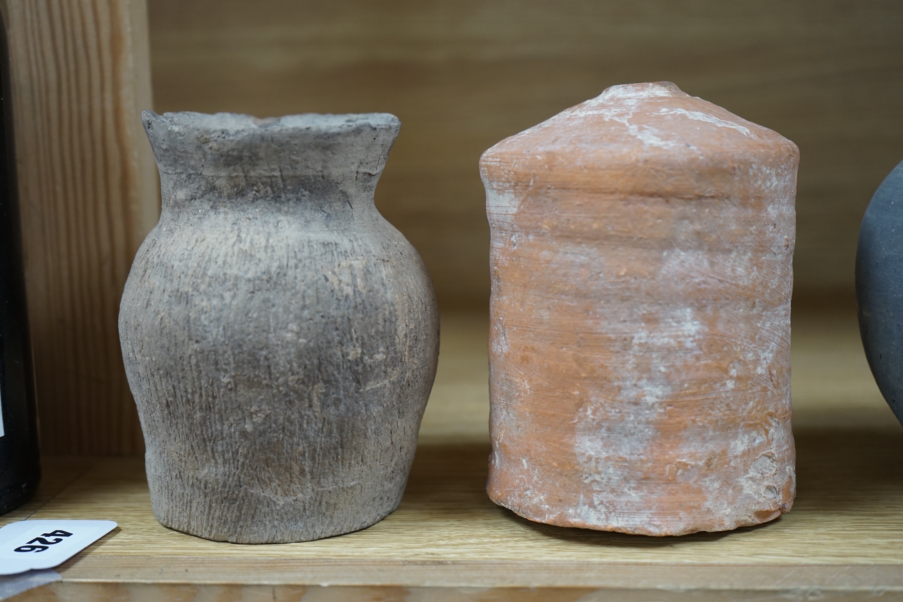 Four Chinese archaic pottery vessels, Neolithic to Han Dynasty, largest 16cm high. Condition - fair, antique condition